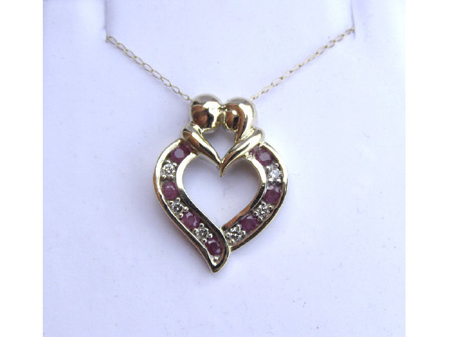 Appraisal: K yellow gold lady's heart design pendant set with rubies