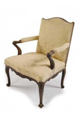 Appraisal: A library open armchair with a shaped back and padded