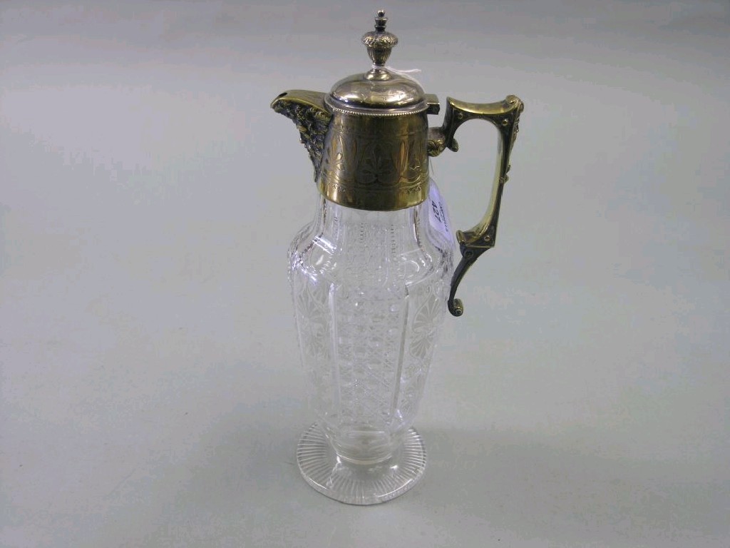 Appraisal: An Edwardian deeply-cut glass decanter with engraved and cast mount