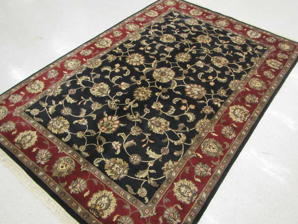 Appraisal: A HAND KNOTTED ORIENTAL CARPET Indo-Persian overall scrolling floral receme