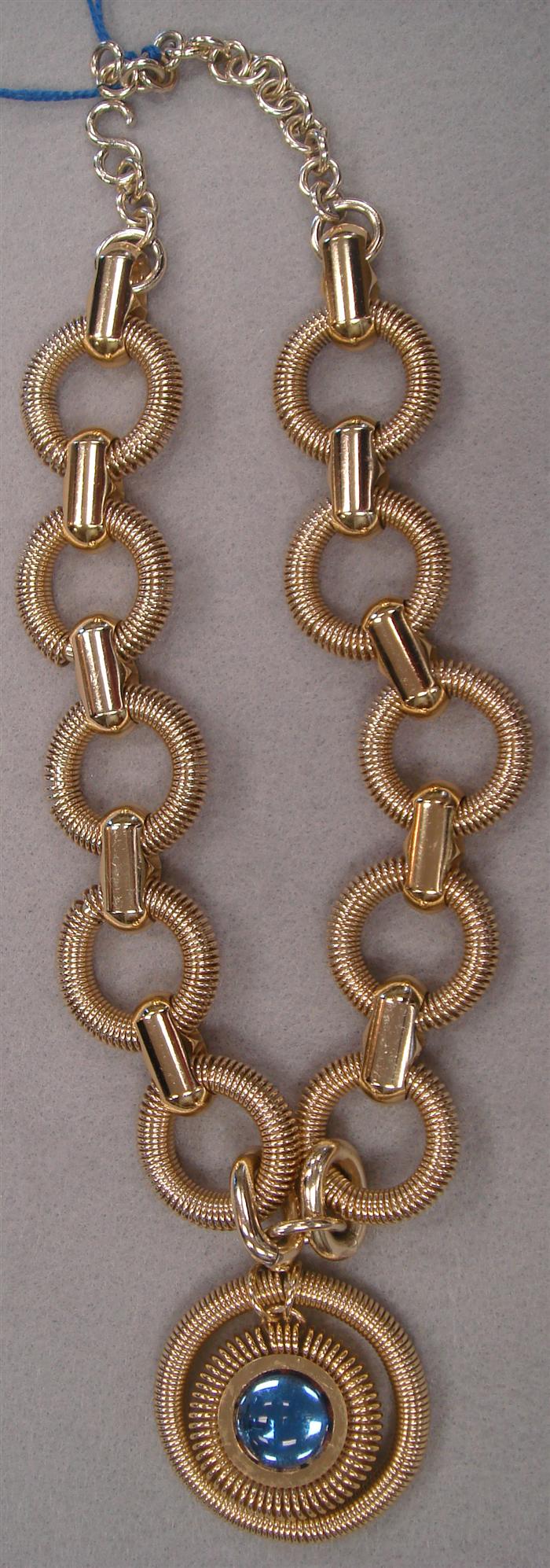 Appraisal: 's gold metal necklace styled with springs with large glass