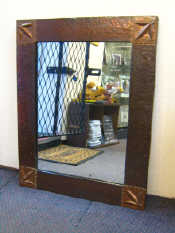 Appraisal: A copper framed Arts and Crafts mirror with hammered finish