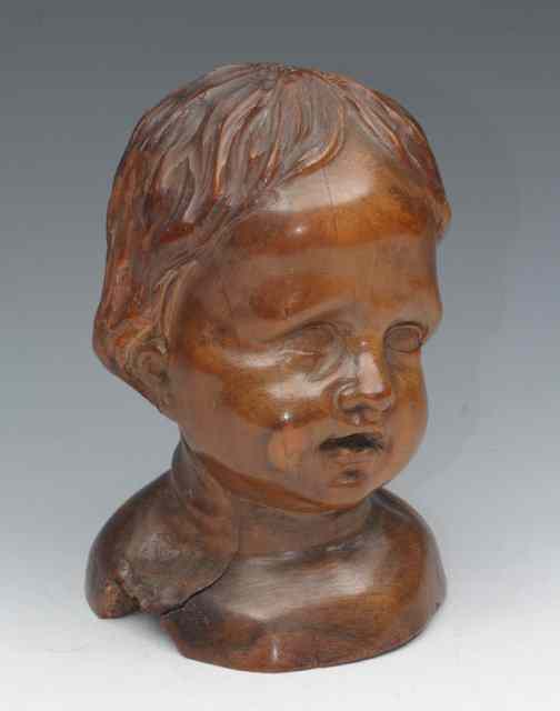 Appraisal: A CARVED OLIVE WOOD BUST of a young boy in