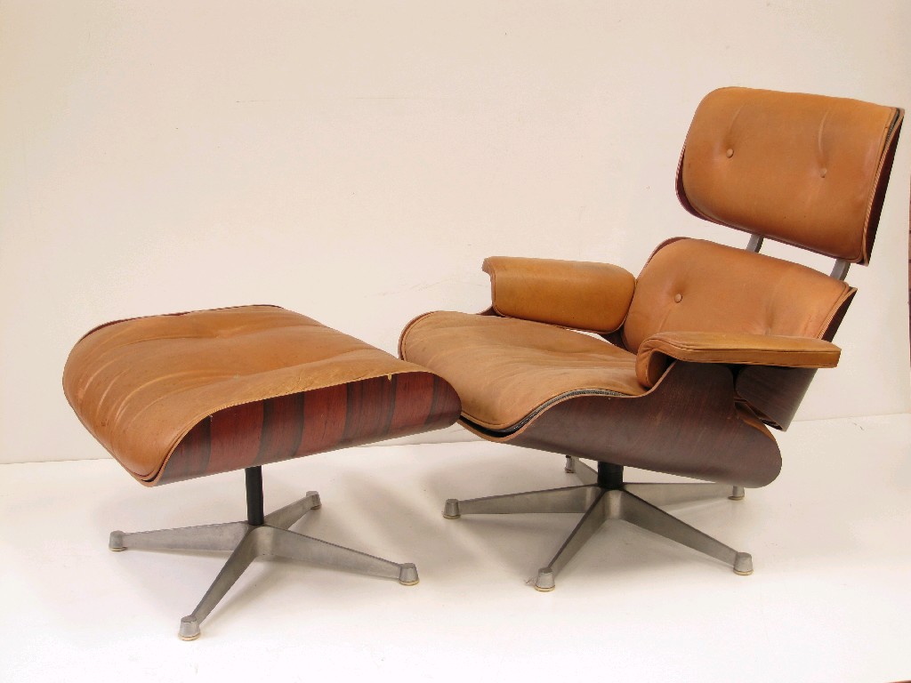 Appraisal: An Eames Revolving Chair and matching Stool with plywood frame