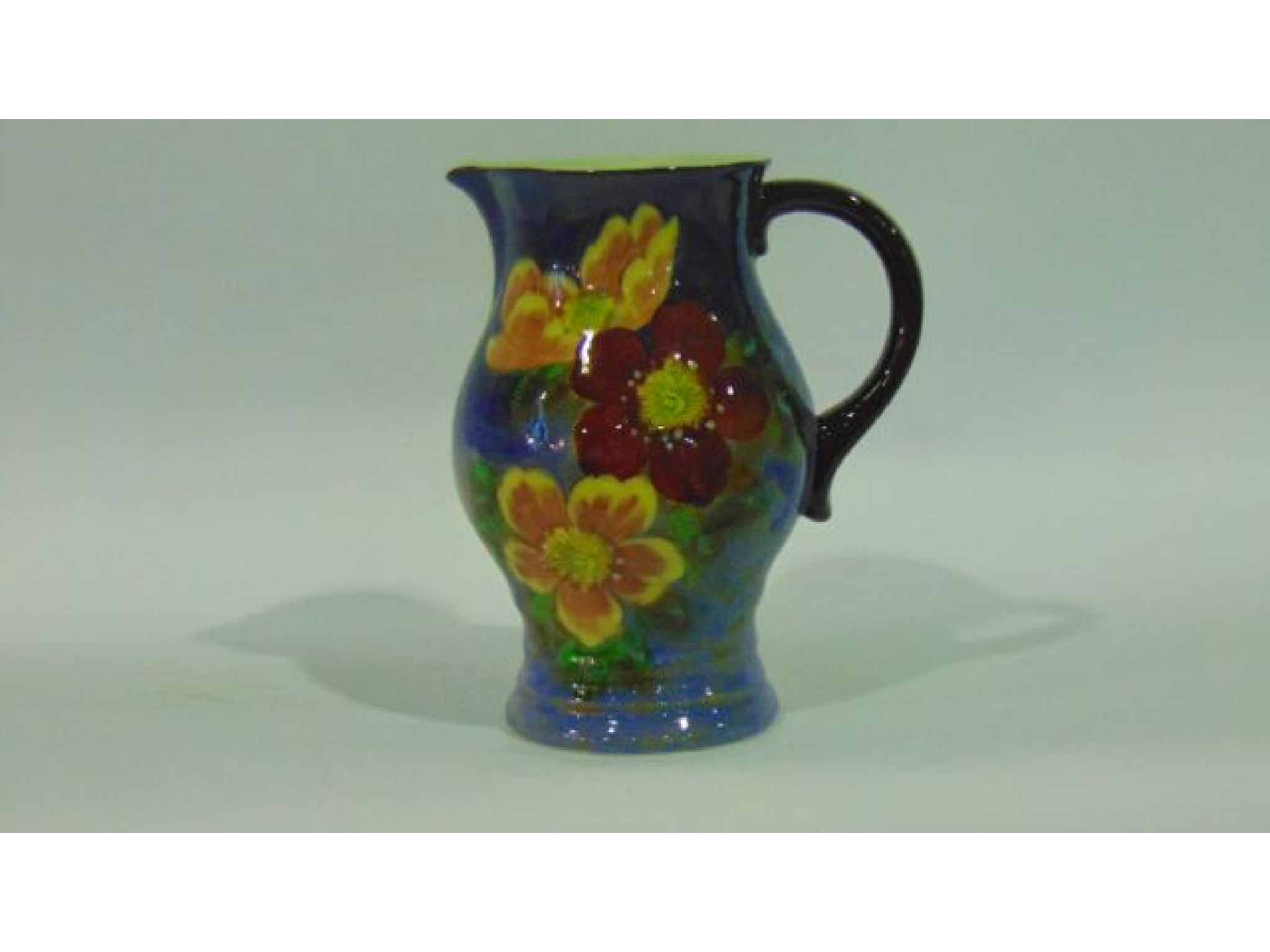 Appraisal: A Royal Doulton jug with painted red and yellow floral