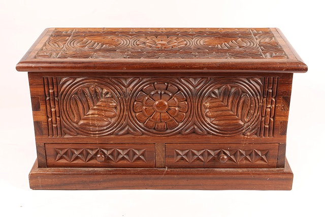 Appraisal: A TANZANIAN CARVED WOODEN CHEST with hinged rising lid and