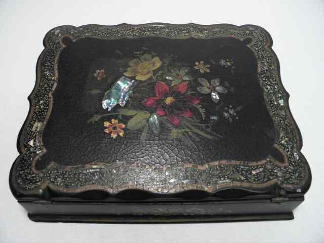 Appraisal: A Victorian lacquered writing box with a hand painted and