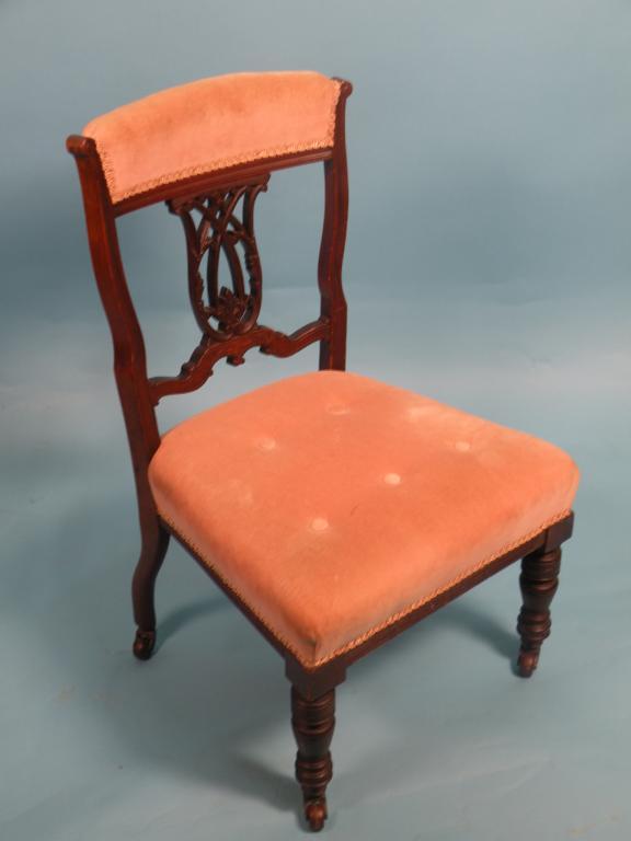 Appraisal: A late Victorian walnut nursing chair with a padded back