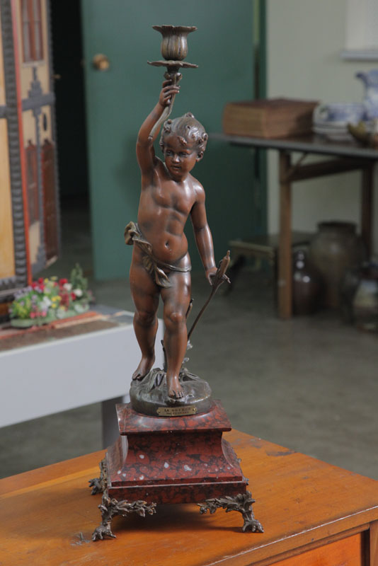 Appraisal: NEWELL POST LAMP A cherub with floriform torch on a