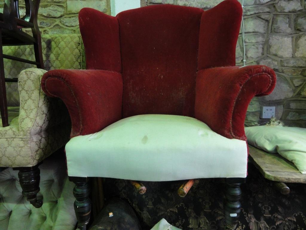 Appraisal: An Edwardian wing armchair with shaped outline serpentine seat raised