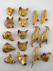 Appraisal: Sixteen silver gilt some enamelled dog and cat masks and