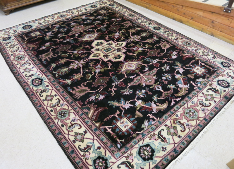 Appraisal: HAND KNOTTED ORIENTAL CARPET Indo-Persian stylized floral and central flower-filled