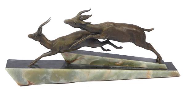 Appraisal: An Art Deco bronze figure of stags on a slate