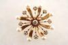 Appraisal: BROOCH -Vintage K yellow gold diamond and pearl starburst form