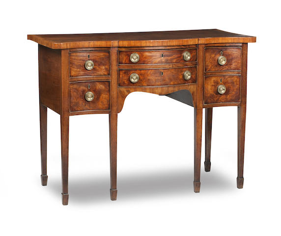 Appraisal: A small George III mahogany serpentine-fronted sideboard The rectangular crossbanded