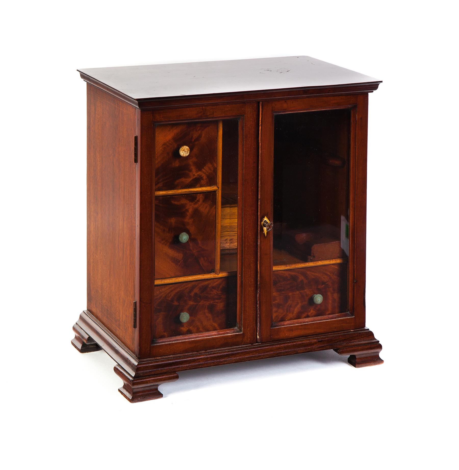 Appraisal: EUROPEAN PIPE SMOKING CABINET Ca mahogany Double doors with beveled