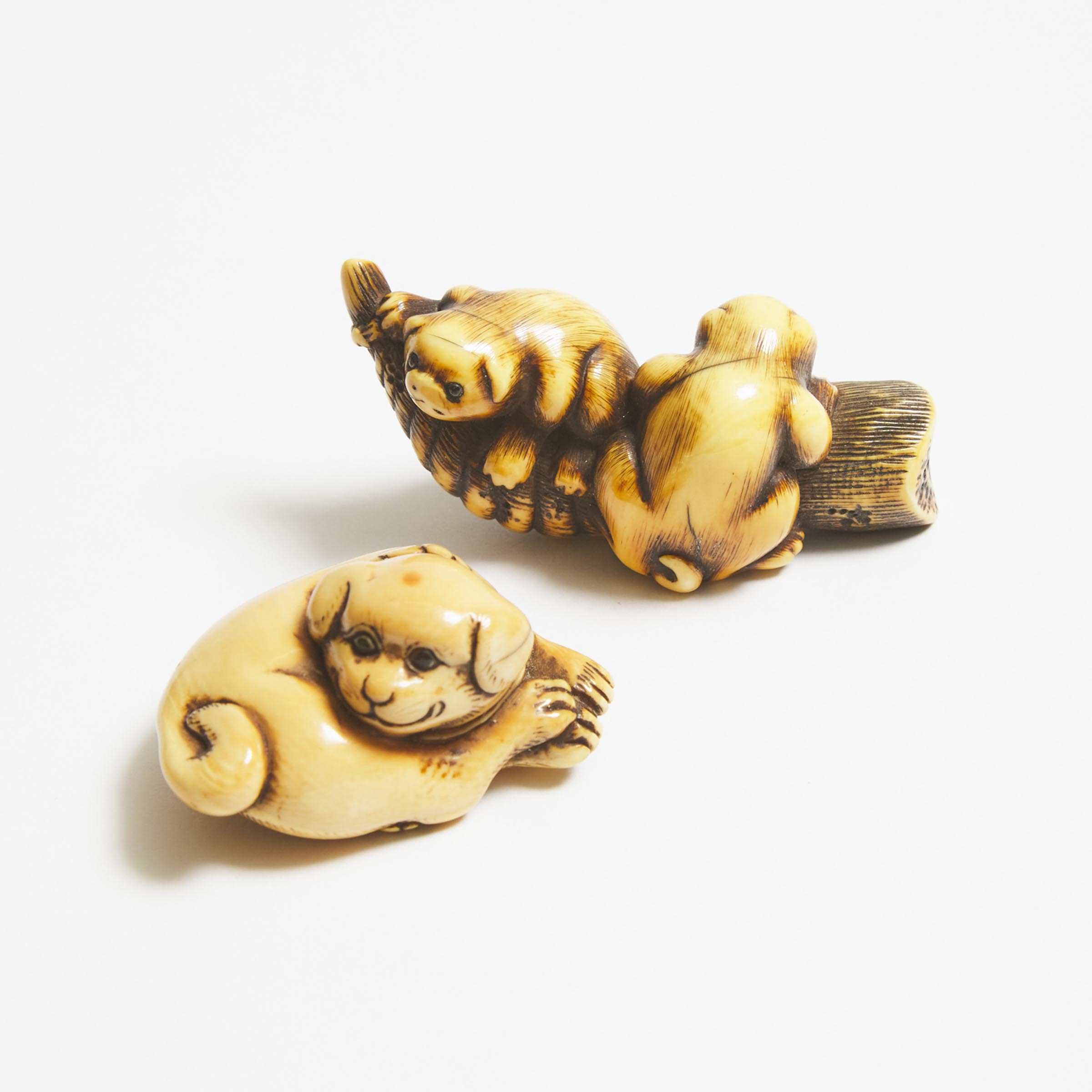 Appraisal: Two Ivory Netsuke of Puppies Early to Mid th Century