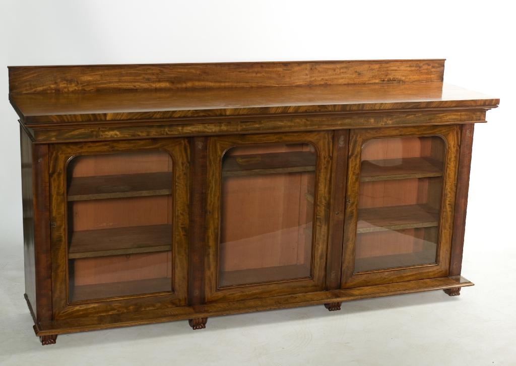 Appraisal: EARLY th CENTURY MAHOGANY GLAZED LOW BOOKCASE the boldly projecting