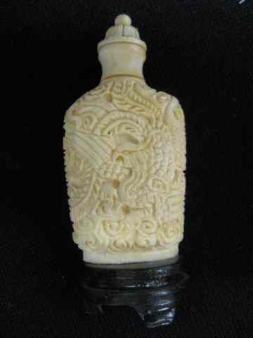 Appraisal: Chinese Carved Ivory Snuff Bottle dragon decor wooden base ''