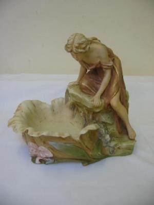 Appraisal: A ROYAL DUX PORCELAIN FIGURAL FRUIT DISH modelled as a