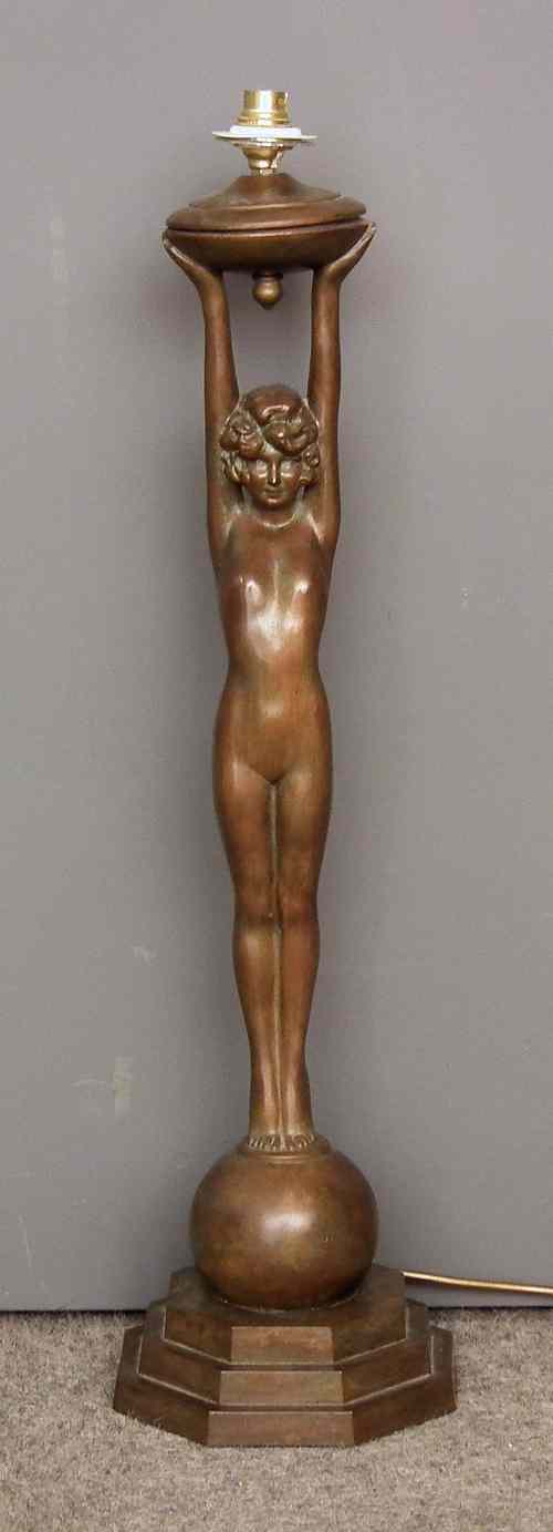 Appraisal: A bronzed metal table lamp modelled as a standing girl