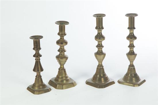 Appraisal: FOUR BRASS CANDLESTICKS American late th century Three with beehive