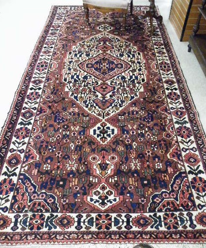 Appraisal: PERSIAN HAMADAN TRIBAL CARPET floral and central flower-filled medallion design