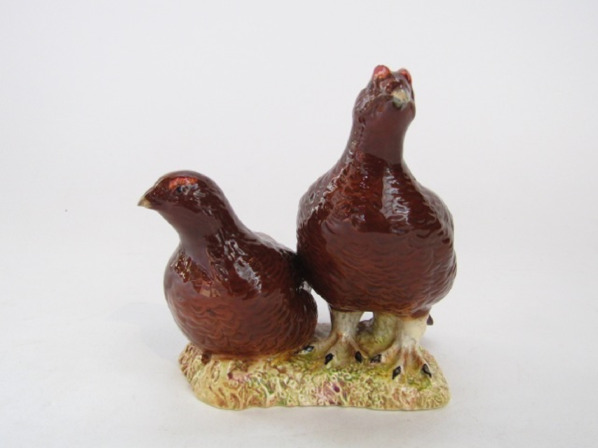 Appraisal: A Beswick group of a pair of red grouse with