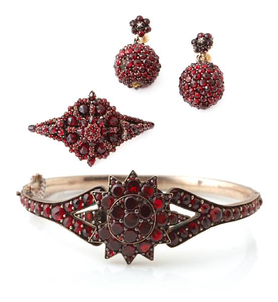 Appraisal: A collection of garnet jewelry comprising of a bangle a