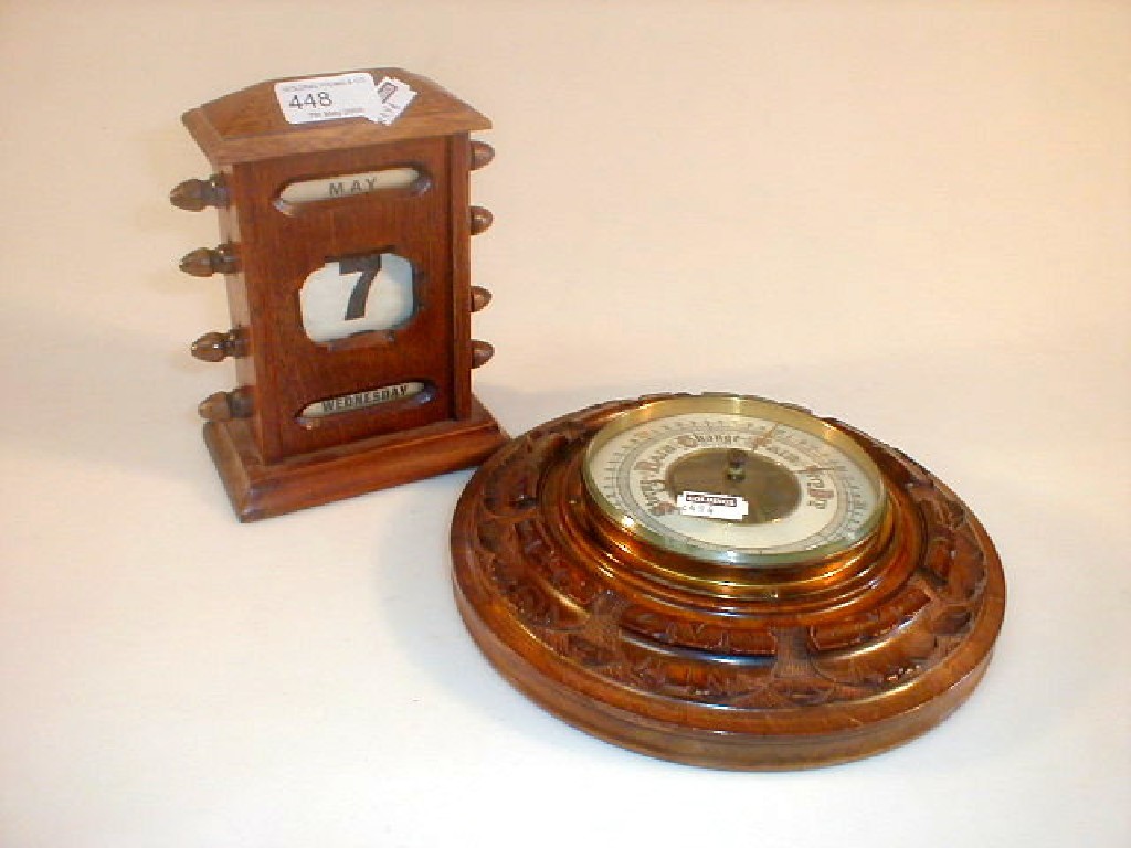 Appraisal: An Edwardian desk calendar and walnut aneroid barometer -