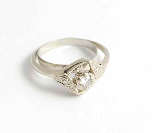 Appraisal: DIAMOND AND FOURTEEN KARAT WHITE GOLD RING the round-cut center