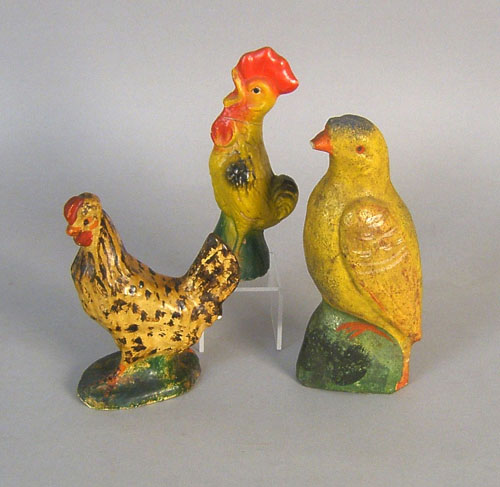 Appraisal: Two composition roosters h and h together with a parrot