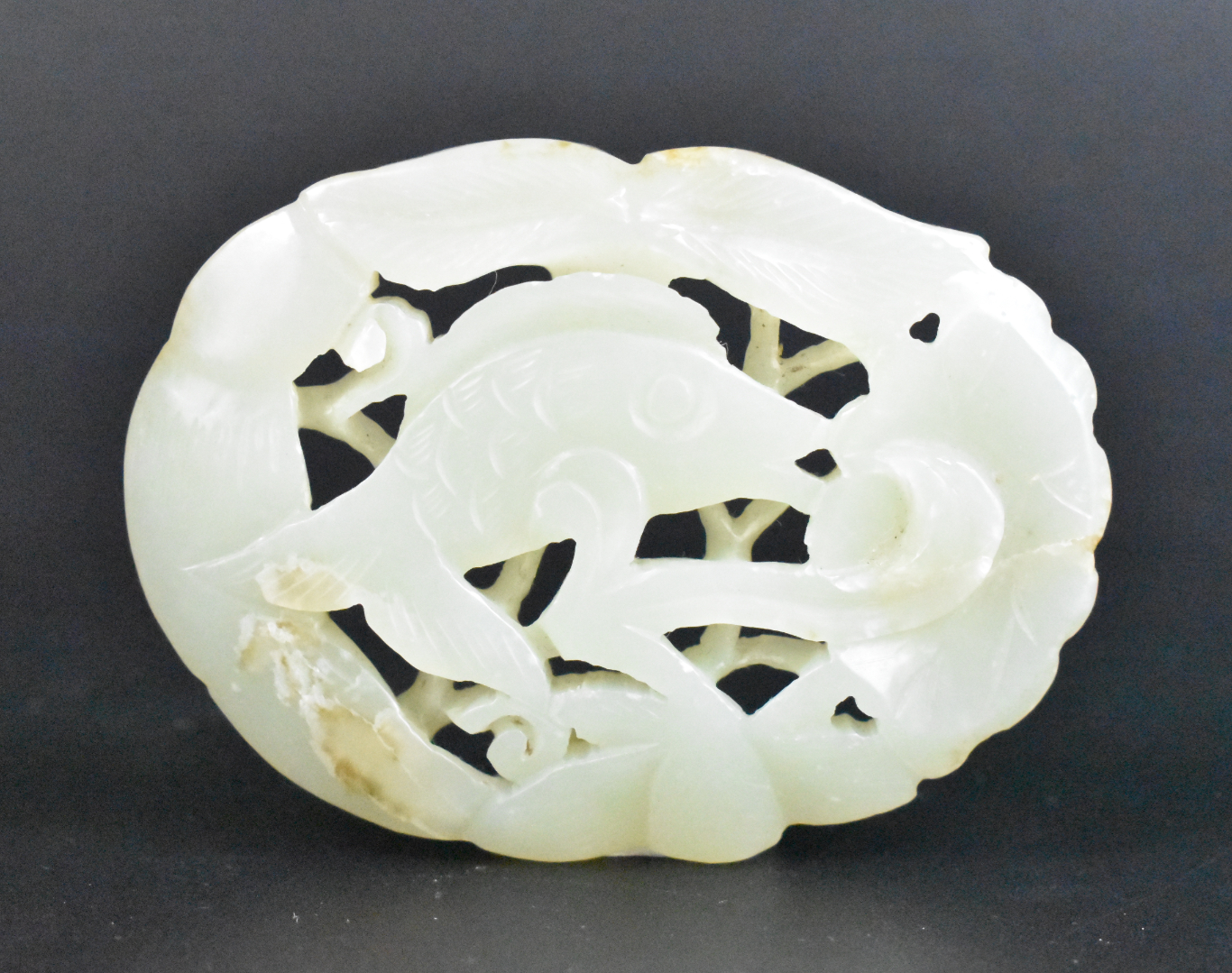 Appraisal: A Chinese white jade carved fish plaque dating from the