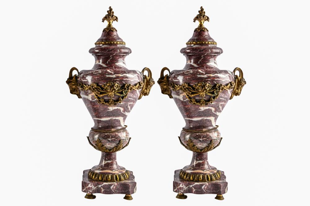 Appraisal: PAIR GILT METAL-MOUNTED MARBLE URNSwith ram's heads suspending garlands Condition