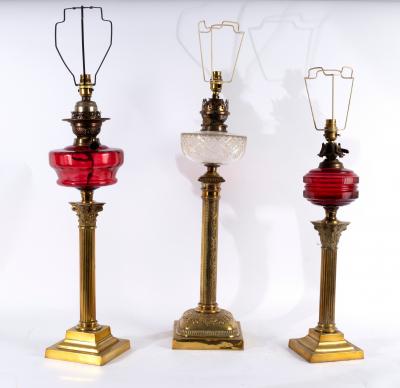 Appraisal: Three oil lamps converted for electricity each with brass column