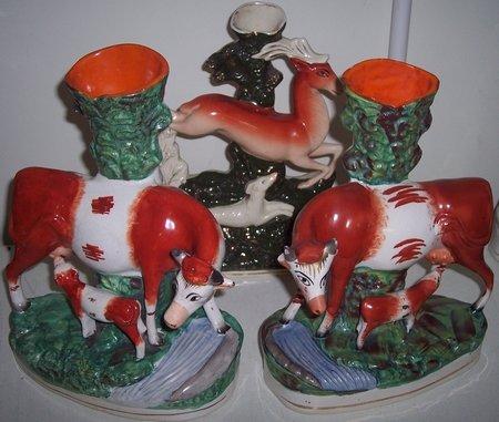 Appraisal: A pair of Staffordshire spill vases modelled as cows with