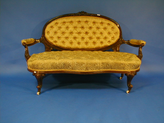 Appraisal: A fine Victorian walnut open armed sofa with oval cameo