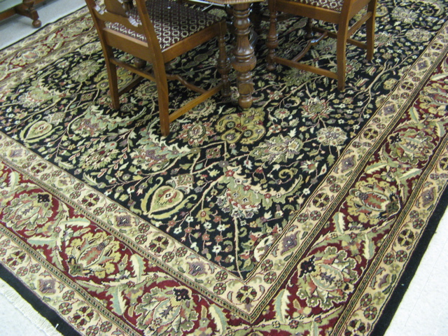 Appraisal: HAND KNOTTED ORIENTAL CARPET Indo-Persian overall floral decoration on black