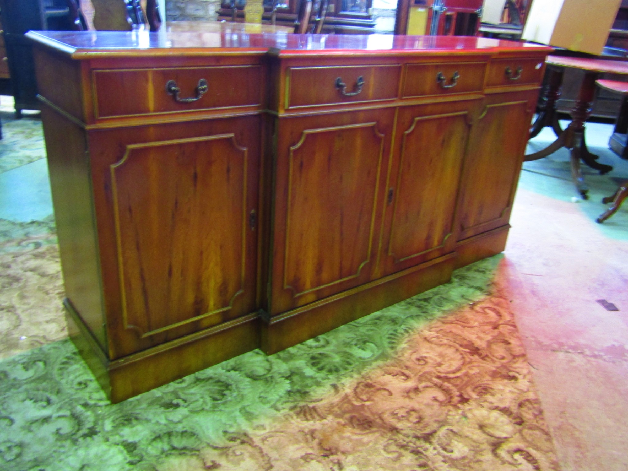 Appraisal: A reproduction yew wood veneered shallow breakfront side cupboard in