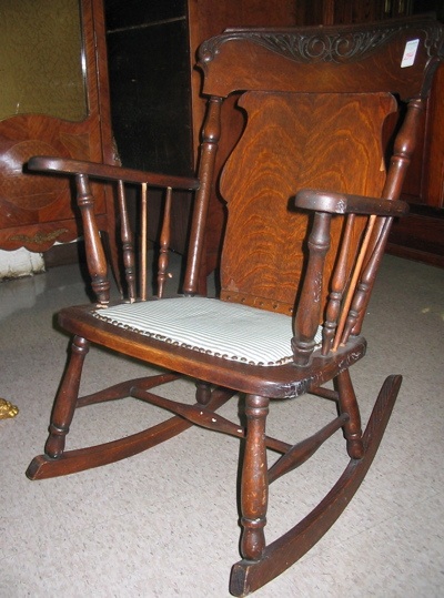 Appraisal: LATE VICTORIAN OAK ROCKING ARMCHAIR American c having a wide