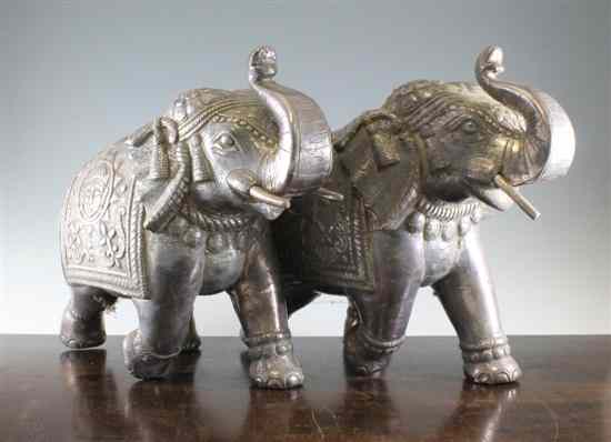 Appraisal: A small pair of Indian silver overlaid elephants decorated with