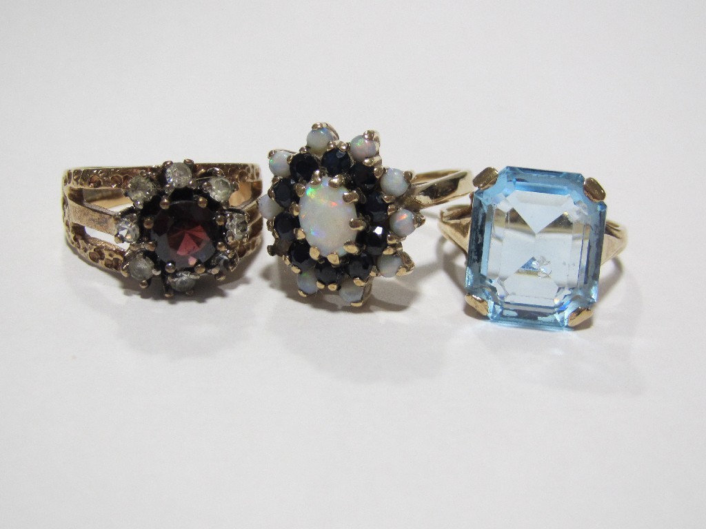 Appraisal: Lot comprising three gold rings to include blue topaz single