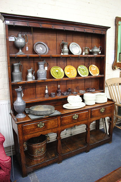 Appraisal: A GEORGE III OAK DRESSER BASE with three drawers above