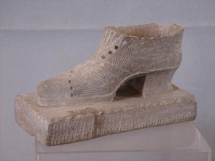 Appraisal: Relief chip carved stone ladies shoe form doorstop chips at