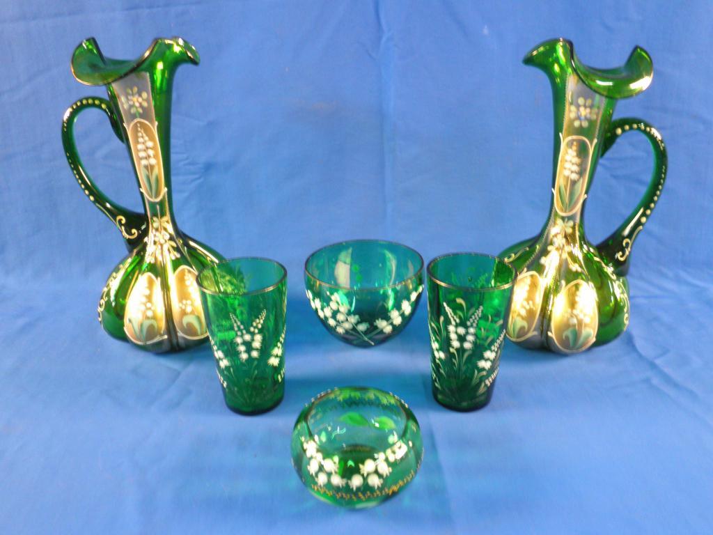 Appraisal: A pair of Victorian green glass ewers each decorated in