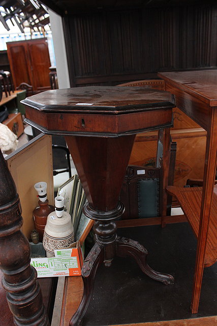 Appraisal: A VICTORIAN WALNUT OCTAGONAL WORK TABLE with lifting lid enclosing