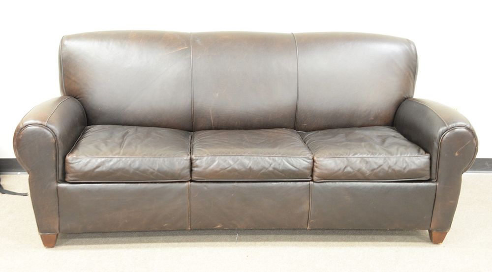 Appraisal: Pottery Barn three-cushion sleeper sofa with brown leather ht wd