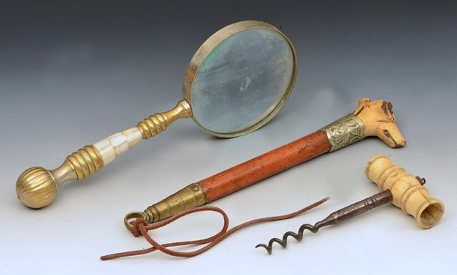 Appraisal: A MAGNIFYING GLASS with turned brass handle an old steel