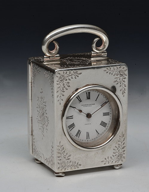 Appraisal: A SILVER CASED TIMEPIECE rectangular shaped standing on bun feet