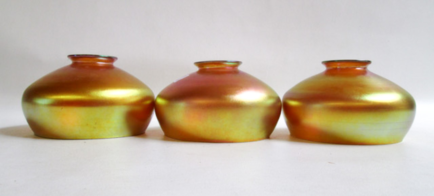 Appraisal: THREE IRIDESCENT ART GLASS SHADES Gold Aurene attributed Steuben bowl